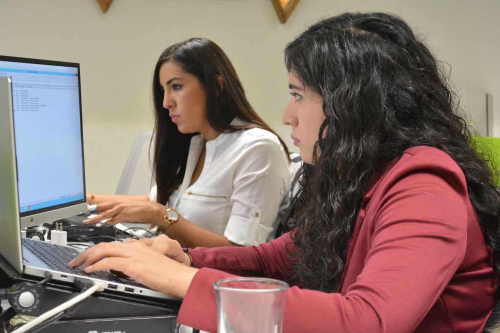 Daevo team members working together at their laptops